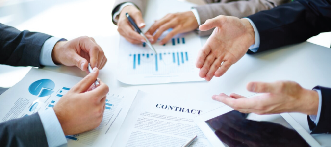 Joint venture partners reviewing a contractor service agreement drafted by HRBD